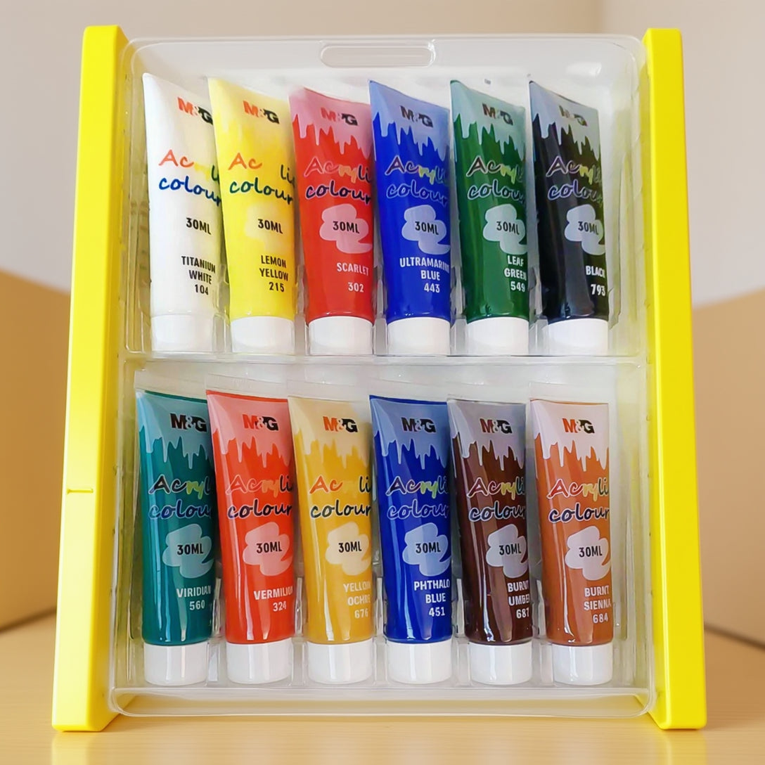 A set of twelve M&G Acrylic Colour paint tubes, each 30ml, organized in two rows of six within a clear plastic tray. Each tube features a white cap and a "dripping paint" graphic design on the label.