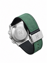 Men's silver skeleton chronograph watch with green leather-style strap and detailed black open-style dial