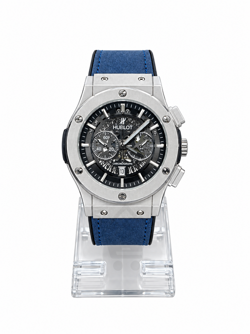 Men's silver skeleton chronograph watch with blue leather-style strap, black open-style dial and silver-tone case