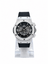 Men's silver skeleton chronograph watch with black leather-style strap, black open-style dial and silver-tone case
