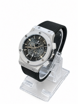 Men's silver skeleton chronograph watch with black leather-style strap, black open-style dial and silver-tone case