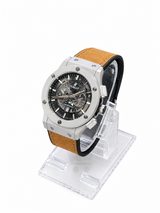 Men's silver skeleton chronograph watch with Light brown leather-style strap, black open-style dial and silver-tone case