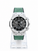 Men's silver skeleton chronograph watch with green leather-style strap and detailed black open-style dial